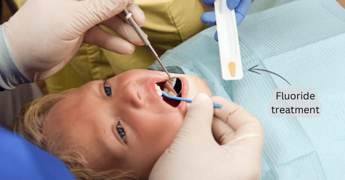 Child receiving fluoride treatment at the dentist to help reverse early tooth decay.