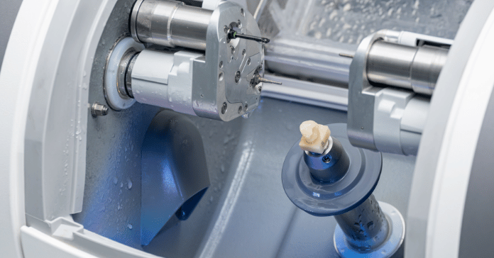 CAD CAM machine milling a dental crown showing advanced technology in modern dentistry.