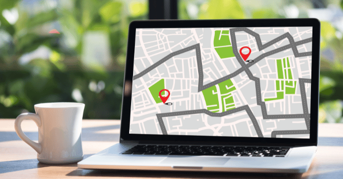 Laptop screen showing a city map with location pins representing nearby dental clinics.